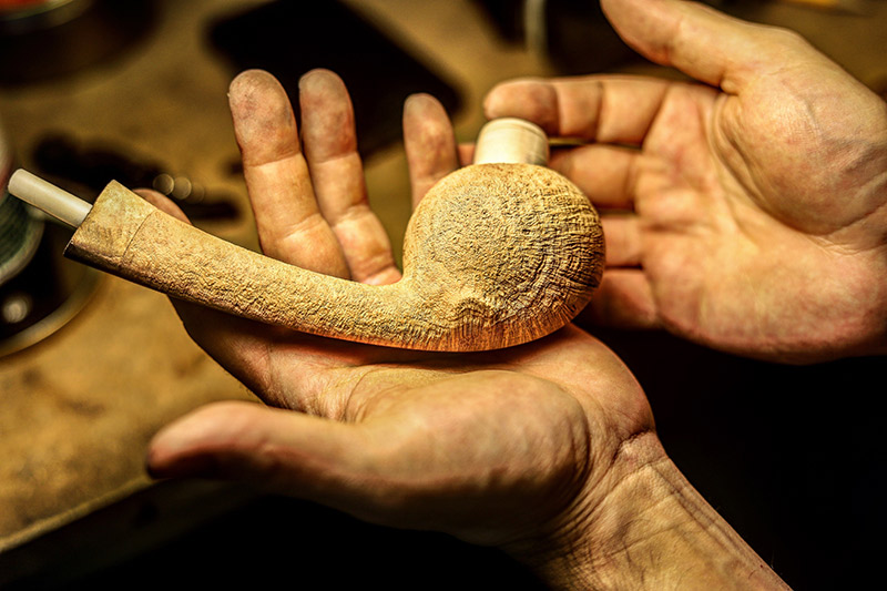 Adam Davidson shaping a tobacco pipe