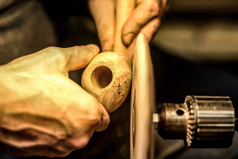 Adam Davidson shaping a tobacco pipe