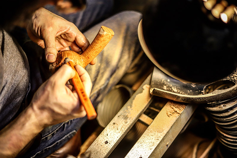 Adam Davidson shaping a tobacco pipe