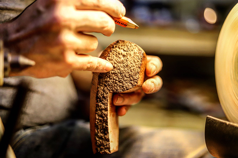 Adam Davidson shaping a tobacco pipe