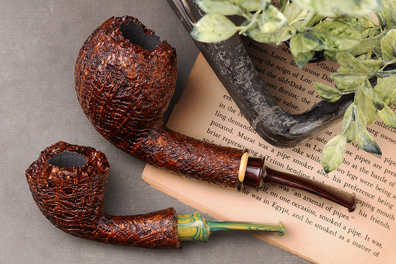 Bill Shalosky rusticated pipes with a marbled green stem resting on an open book