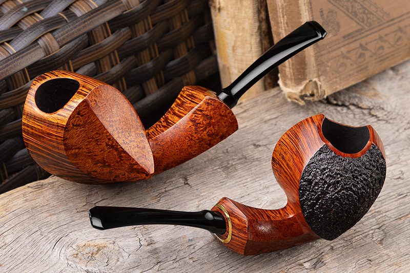 David Huber smooth birdseye pipe and sandblasted pipe on a wicker background
