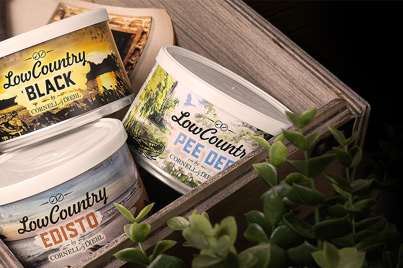 Low Country Black, Edisto, and Pee Dee pipe tobacco tins in a wooden crate